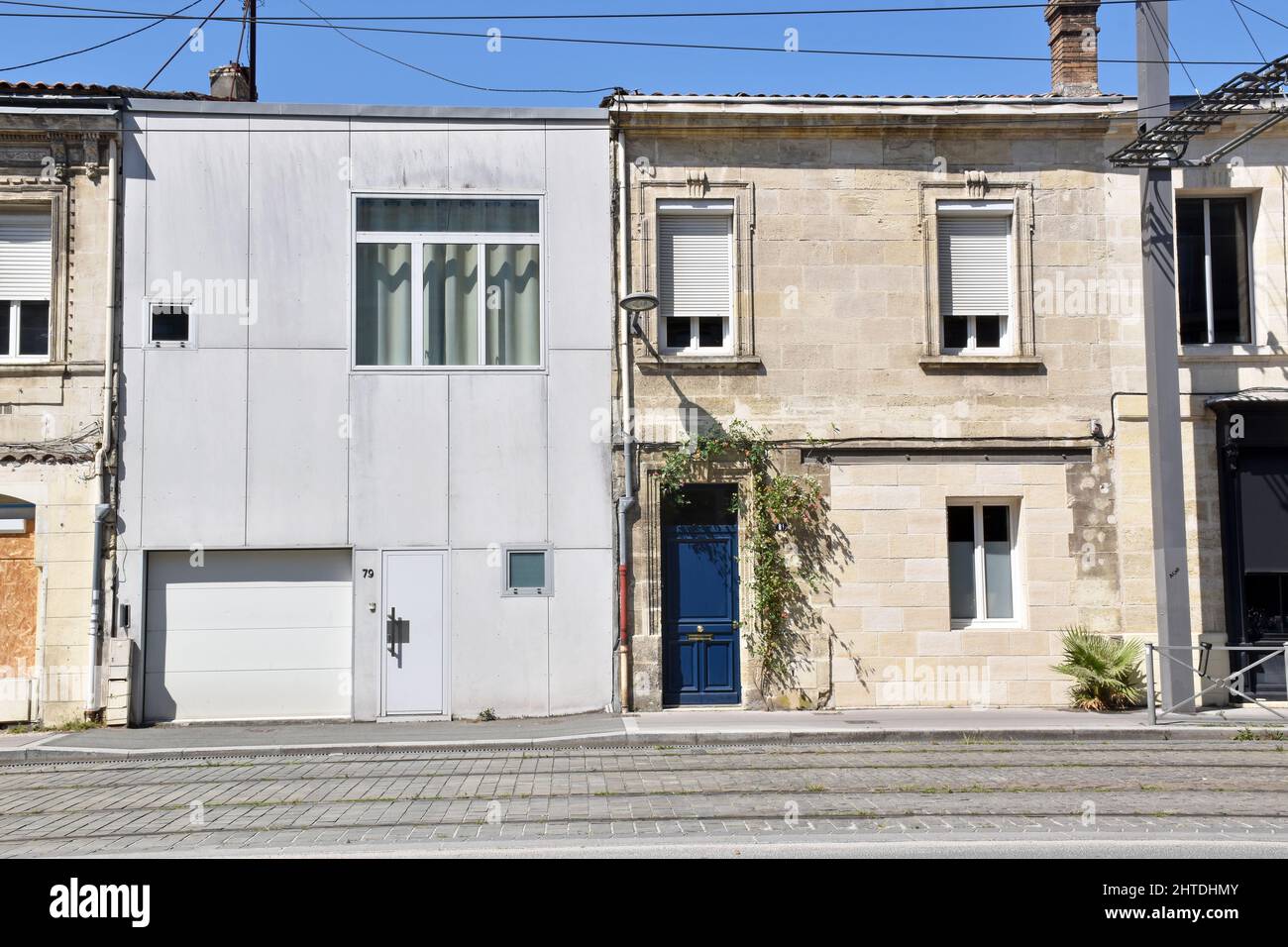 Two adjoining small houses, one in its original state, the other unsympathetically replaced or rebuilt. How not to do redevelopment, Bordeaux, France Stock Photo
