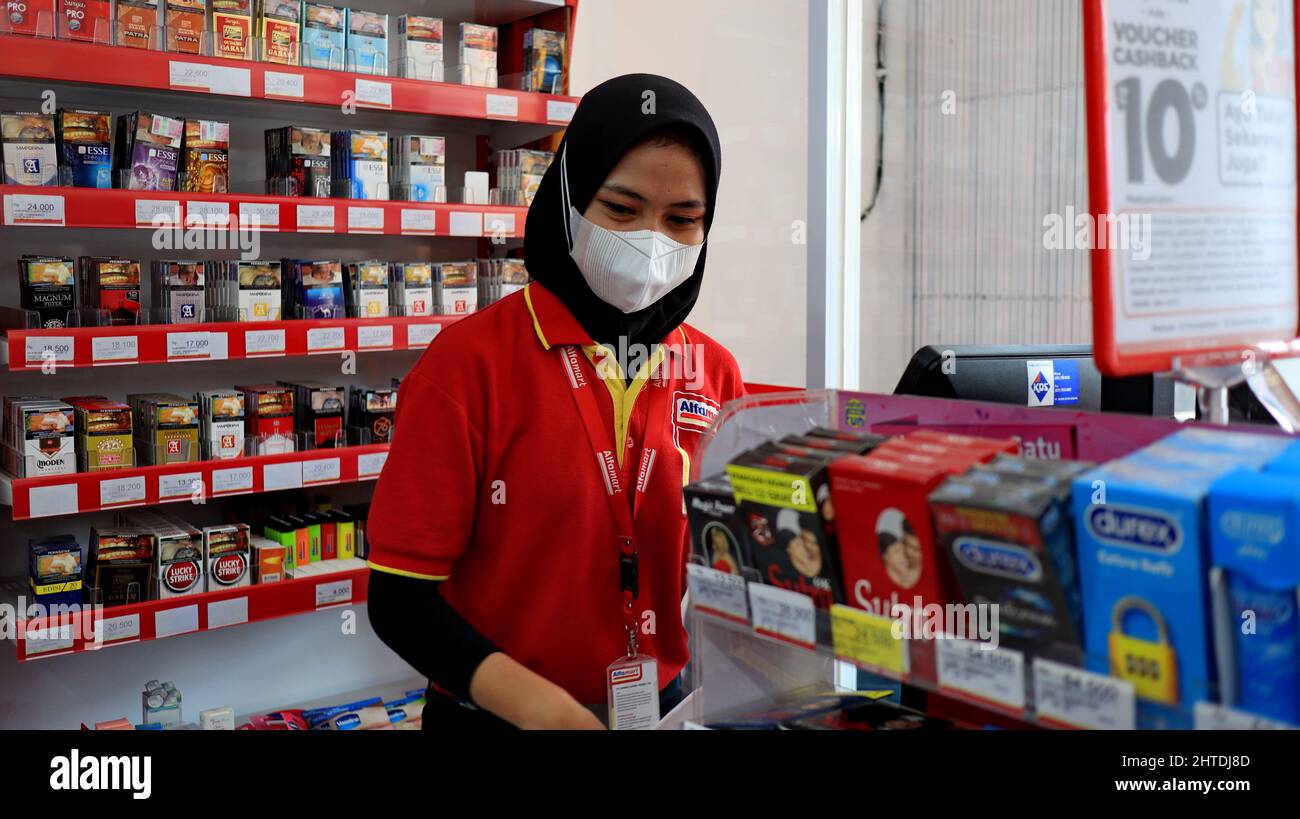 Female in a hijab and a covid mask working at a store in Alfamart, Batang Indonesia Stock Photo