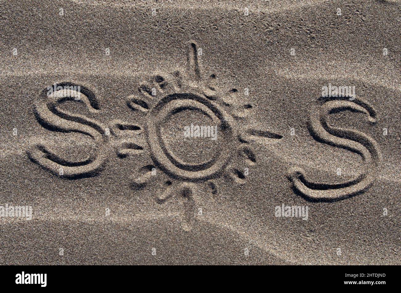 Sos message written on sand hi-res stock photography and images - Alamy