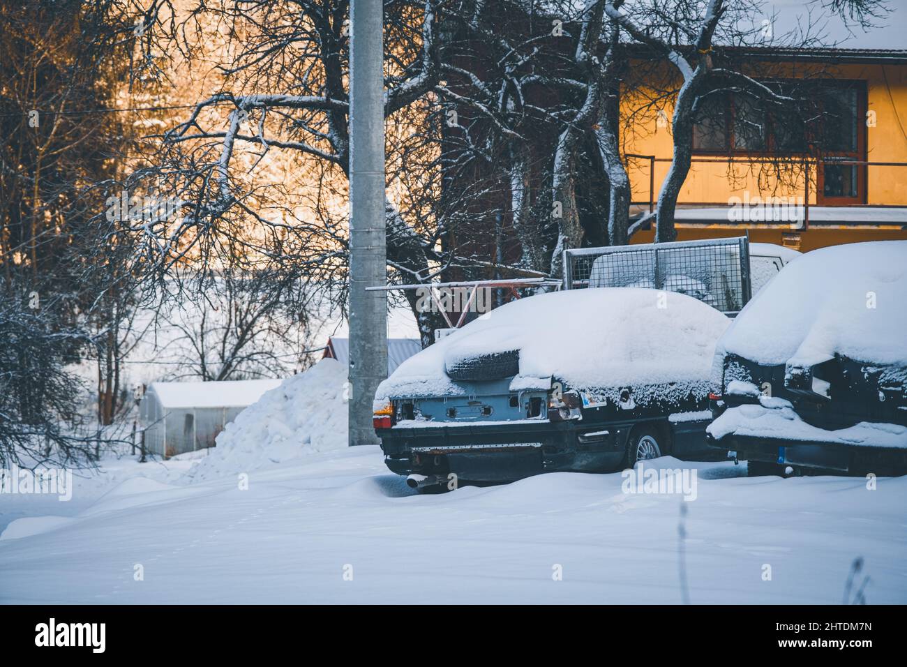 Abandoned cars covered with snow - Abandoned Cars Covered With Snow In Front Of A Building 2HTDM7N