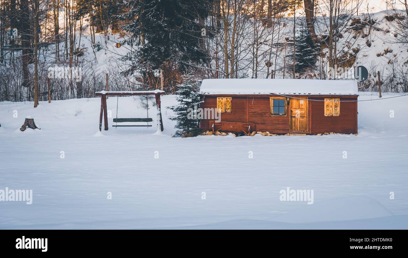 Wooden house in a snowy forest Stock Photo - Alamy