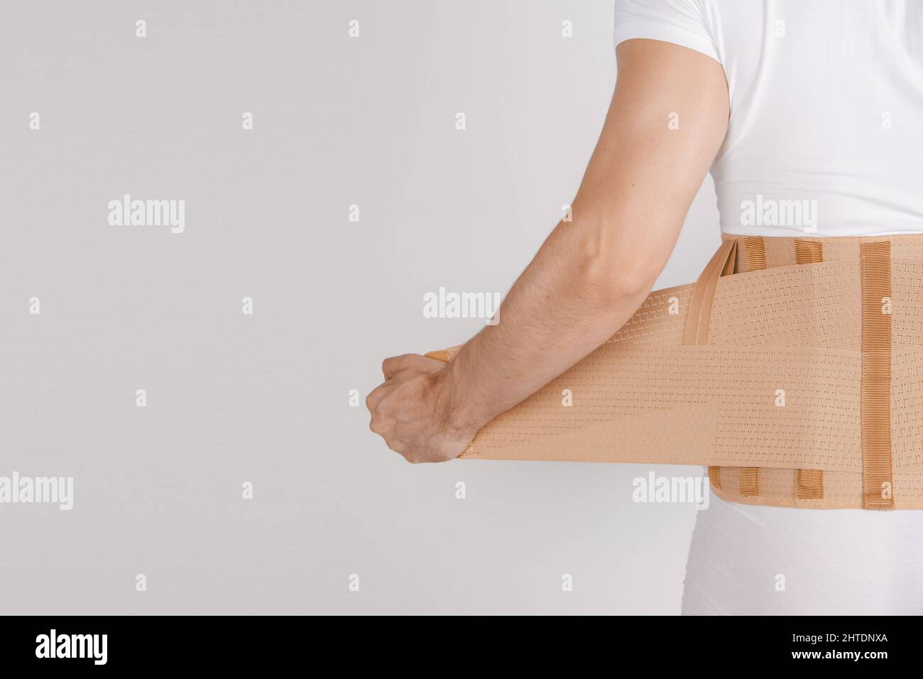 Lumbar brace on the human body isolated on a white background. Trauma