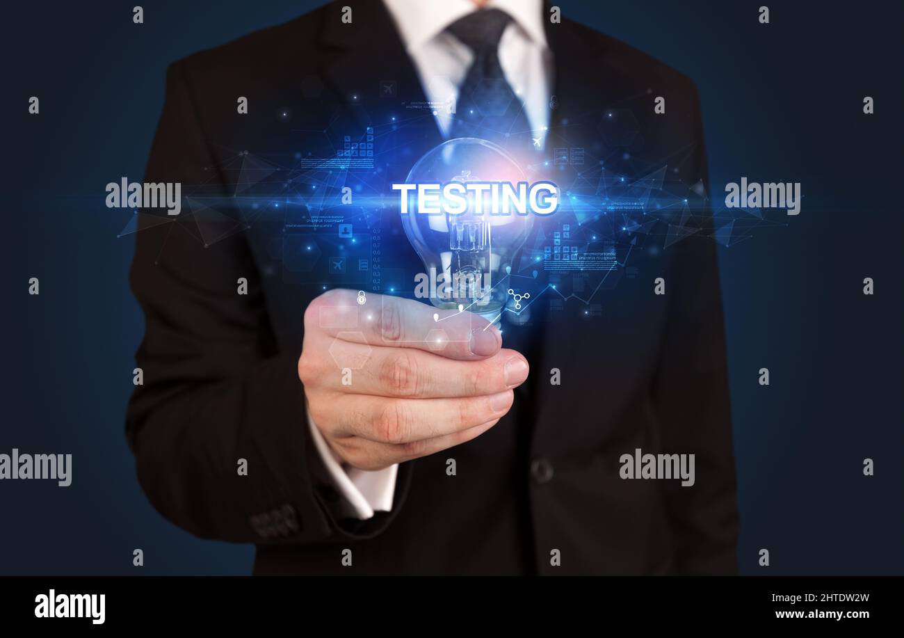 Businessman holding a light bulb Stock Photo - Alamy