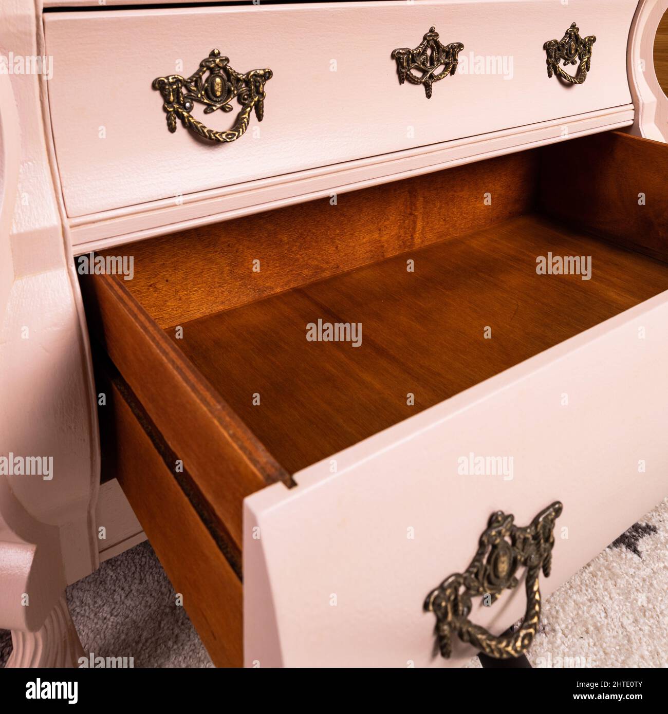 Pink chest of drawers after renovation painted in color Stock Photo Alamy
