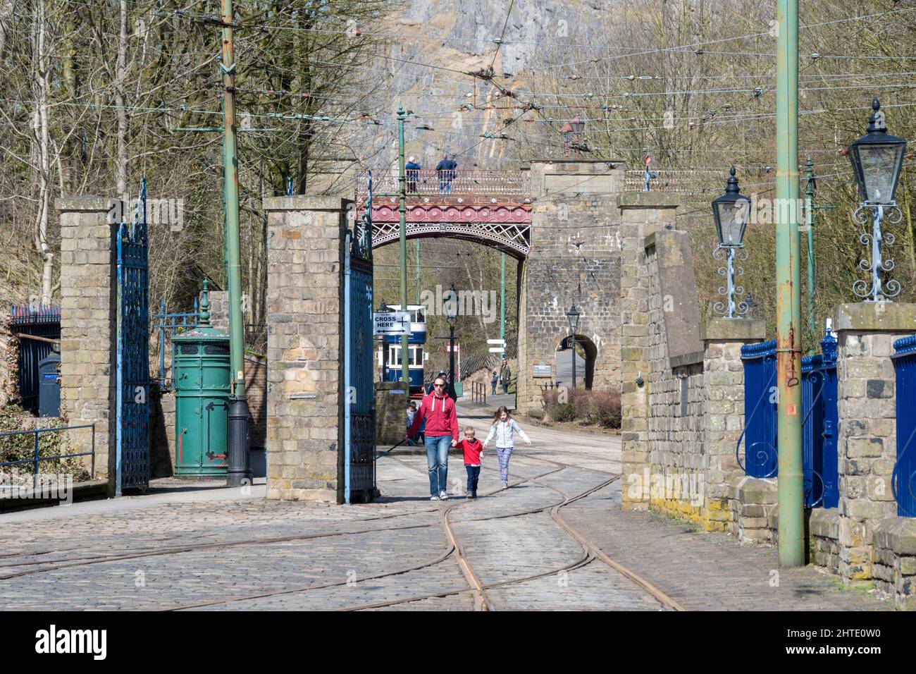 Derbyshire, UK – 5 April 2018: A family walk the tram tracks at Crich Tramway Village National Tram Museum Stock Photo