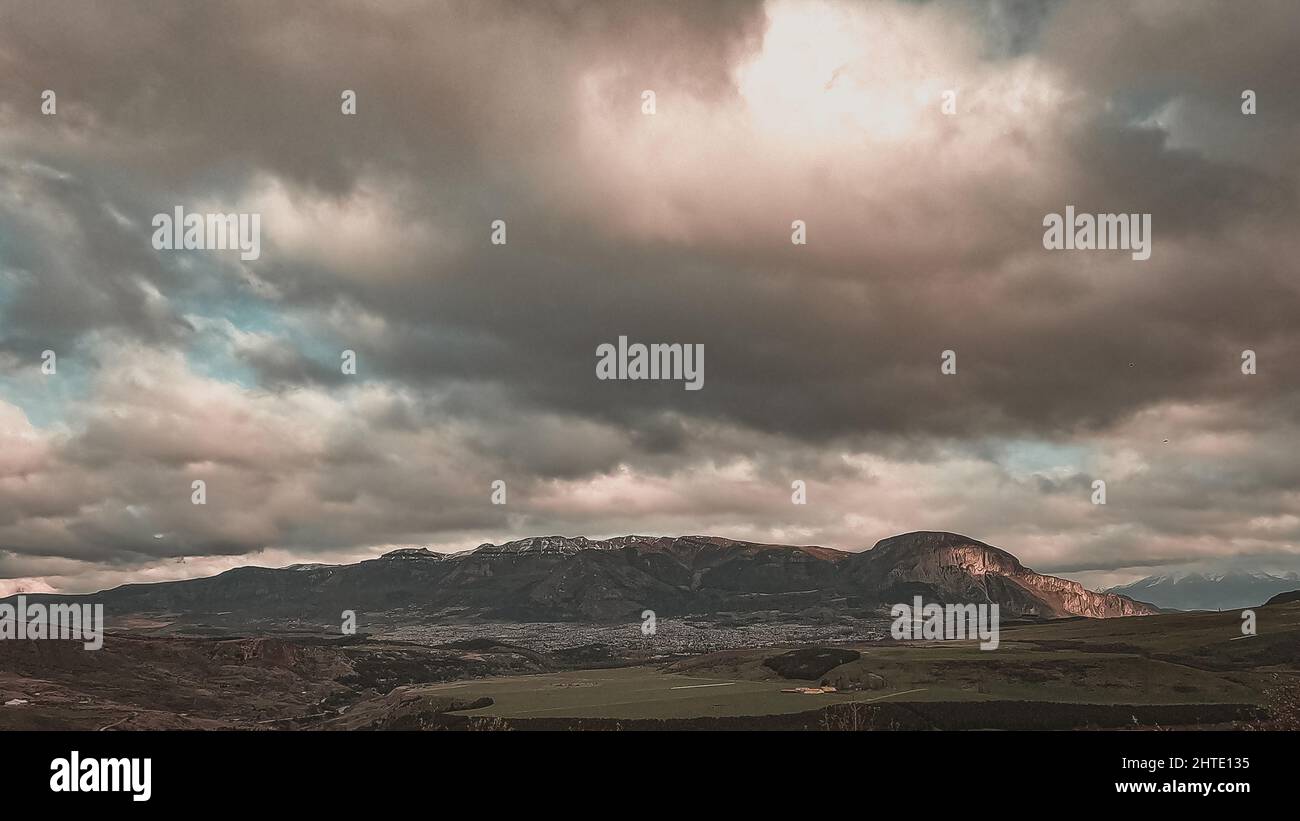 Photo of a landscape showing a mountain, land, and a cloudy sky Stock ...