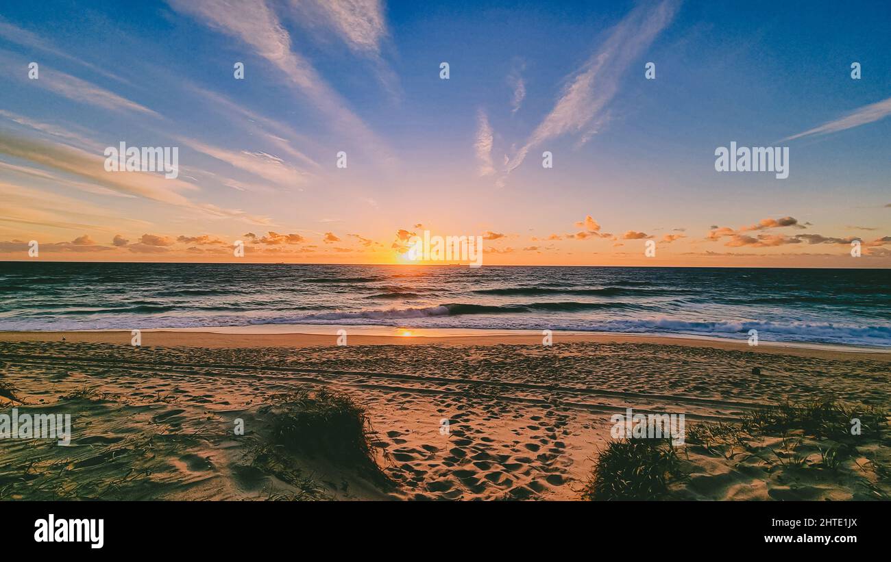 Beautiful scenery of a tranquil sea with a breathtaking sunset ...