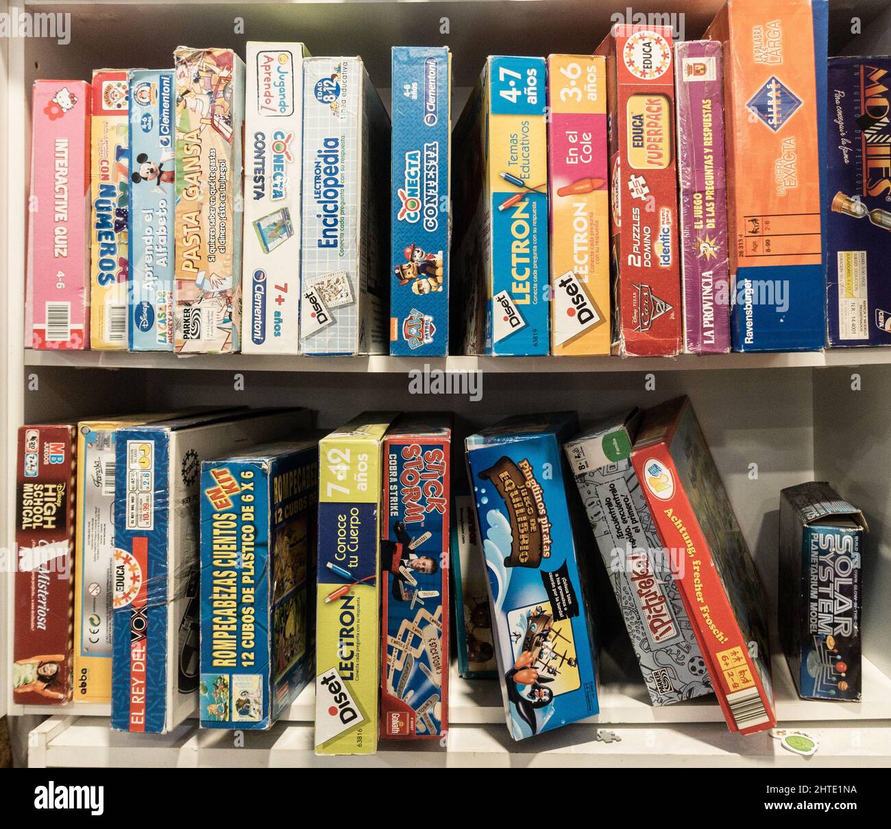 Board games and boxes of toys in charity shop. Stock Photo
