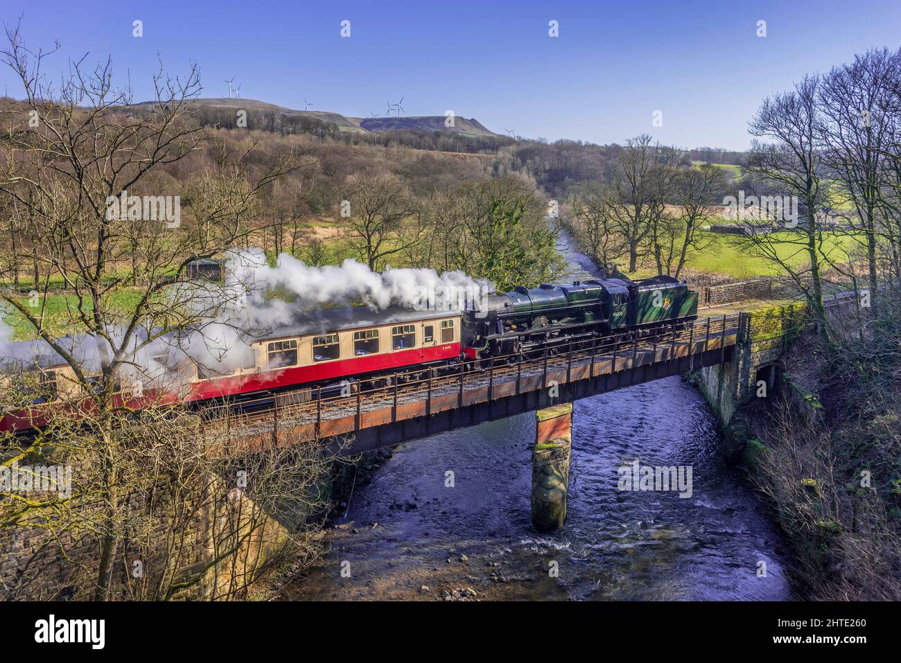LMS Royal Scot No. 46100. Royal Scot crossing the river Irwell at Alderbottom on the East Lancashire Railway during the 2022 Spring Steam Gala heading Stock Photo
