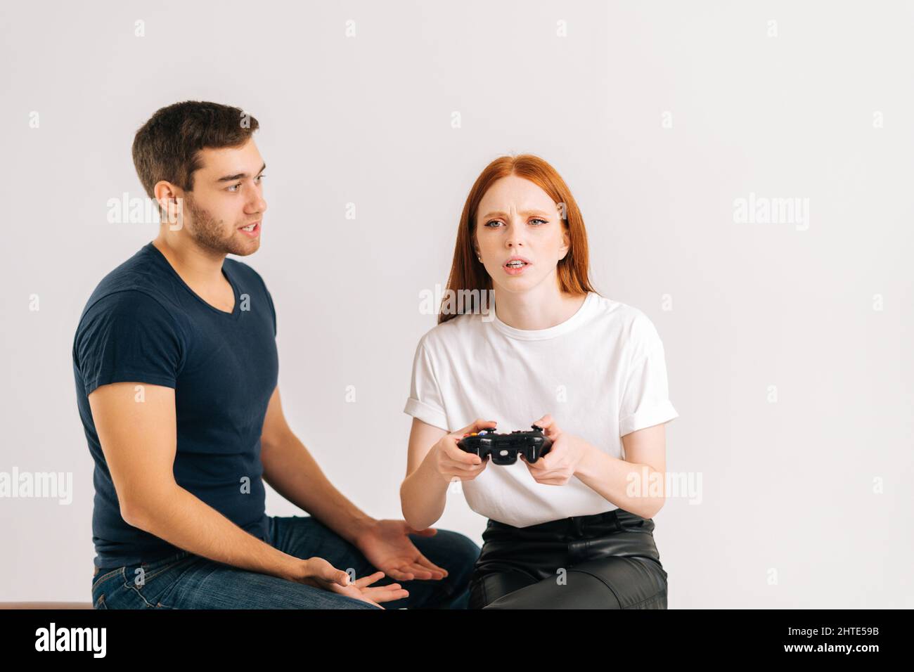 Premium Photo  Boyfriend sits engrossed in playing online games on his  smartphone, ignoring his girlfriend waiting.