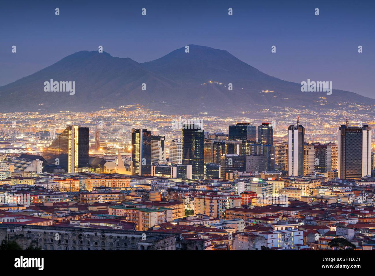 Naples, Italy with the financial district skyline under Mt. Vesuvius at twilight. Stock Photo
