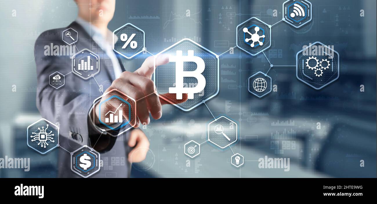 Man clicks on a virtual screen bitcoin icon. Stock Photo