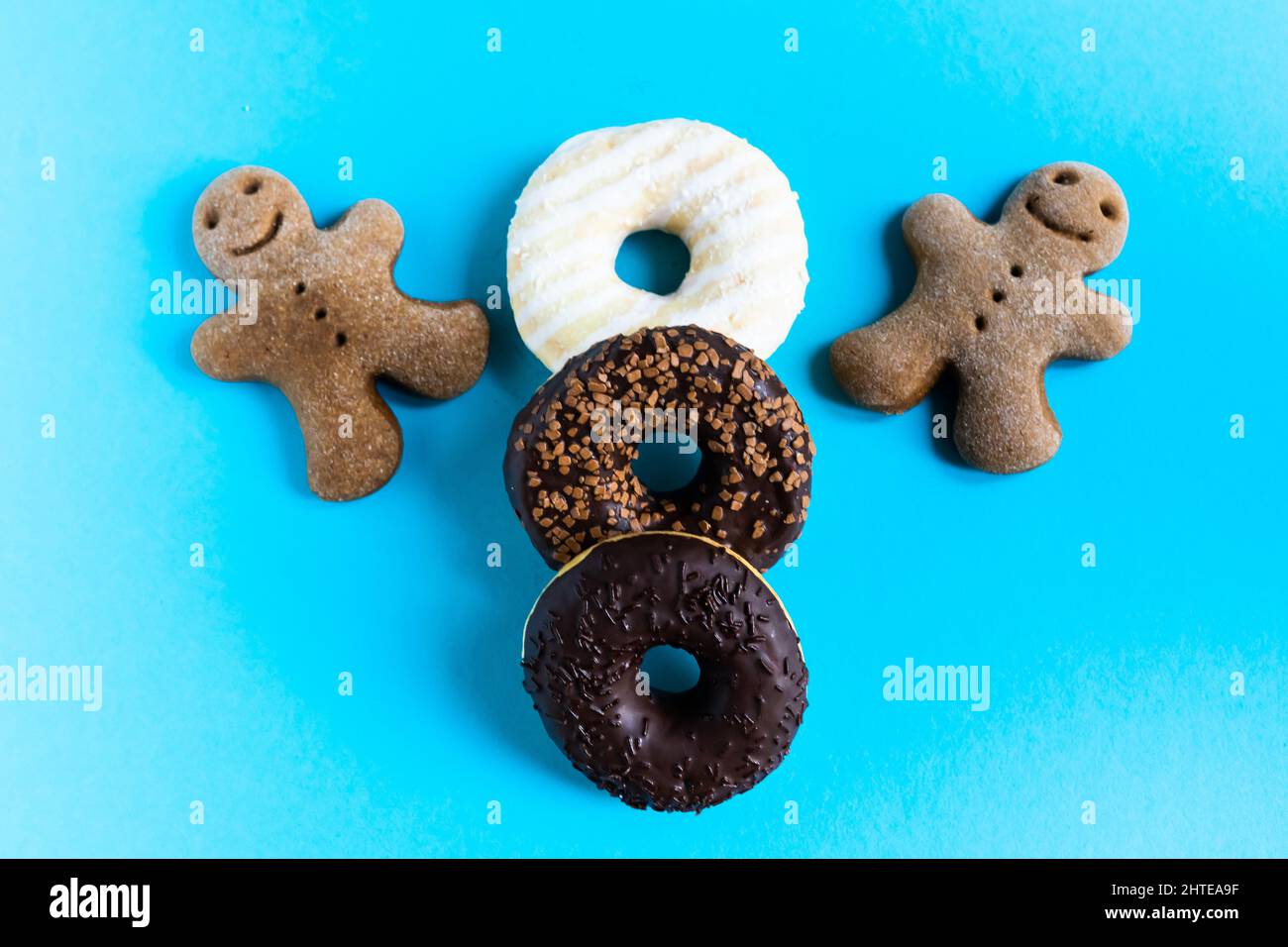 Donut with hazelnuts on a blue background, close up Stock Photo