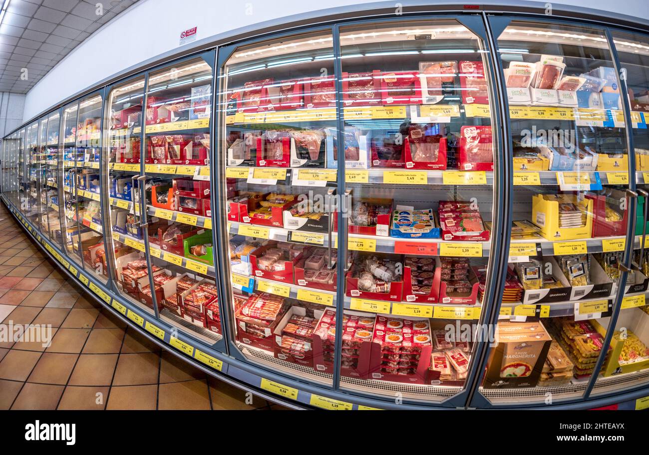 Fossano, Italy - February 26, 2022: Refrigerated showcases with packs of Salami, ham, cheese with affordable prices in INS italian discount store, INS Stock Photo