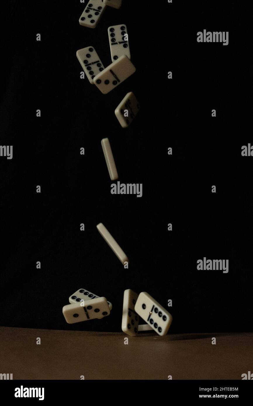 Selective focus shot of domino tiles falling from the above to the ...