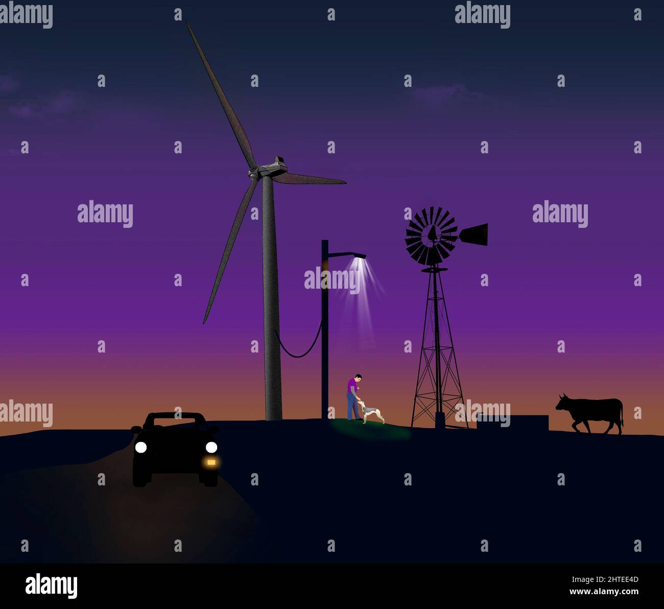 An old water pumping windmill stands in contrast to the giant energy producing windmills on this