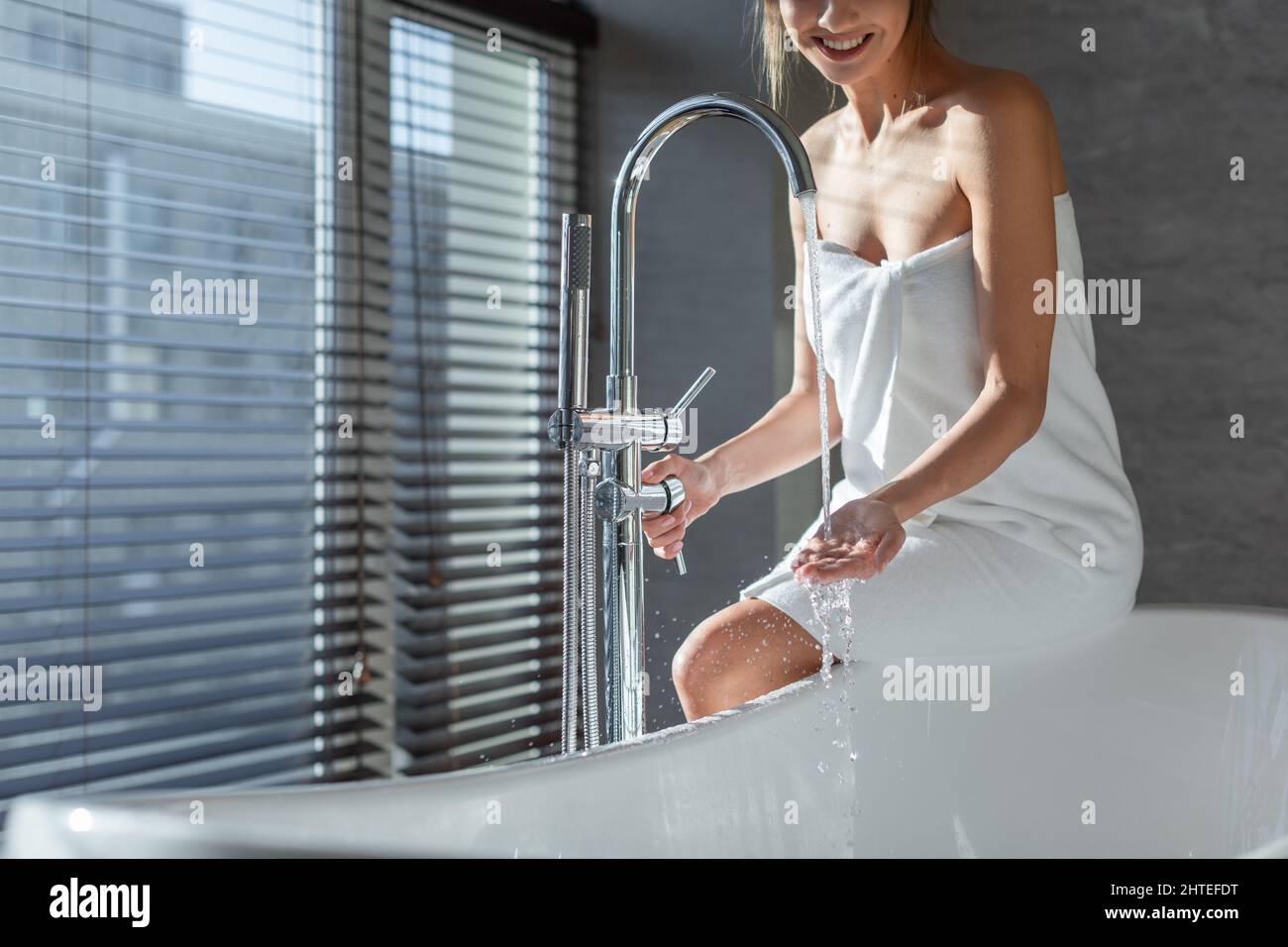 Beautiful Young Female Wrapped In Towel Preparing To Take Bath Stock Photo