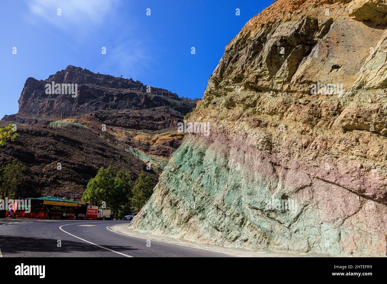 The GC-200 in western Gran Canaria cuts through the colourful rock formations of los azulejos de veneguera Stock Photo