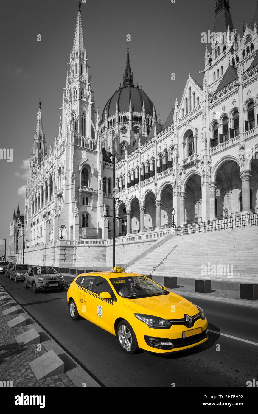 Vertical selective color shot of a Renault taxi near the Hungarian parliament building in Budapest Stock Photo
