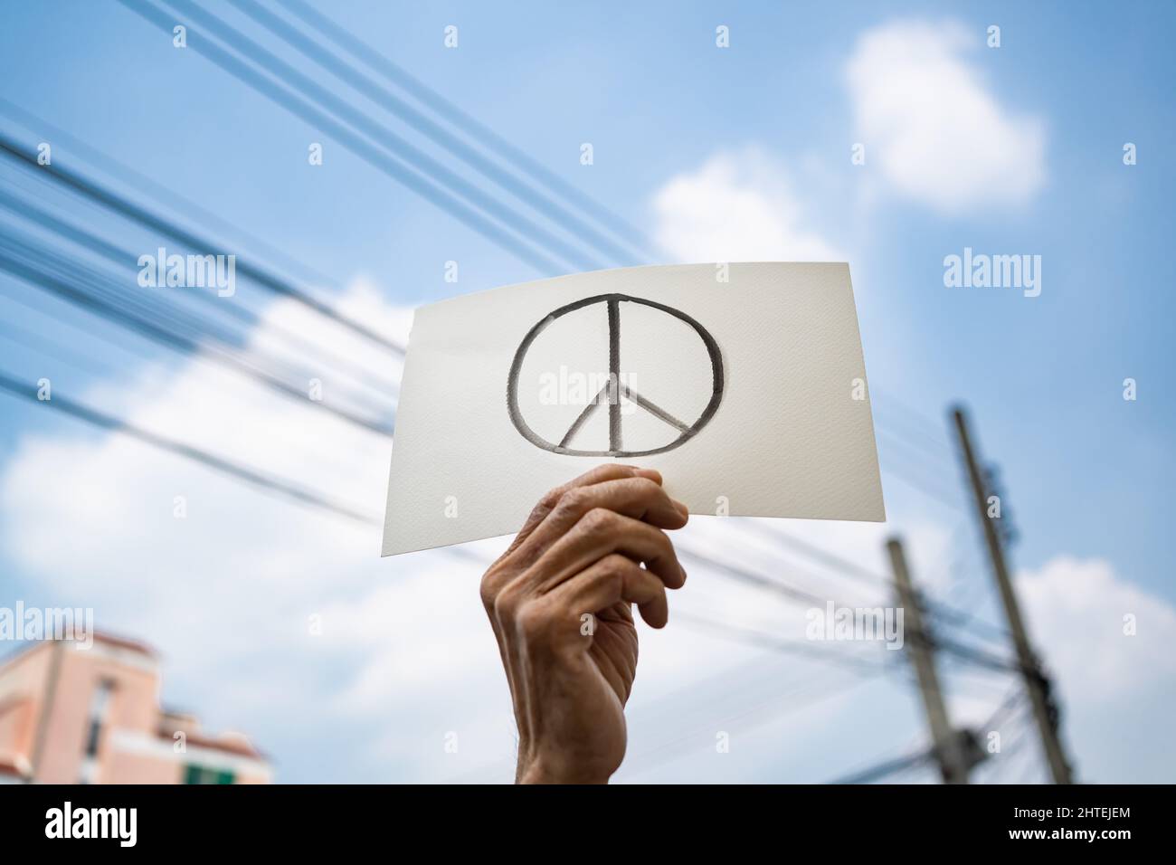 Demonstrator holding paper with peace symbol Stock Photo