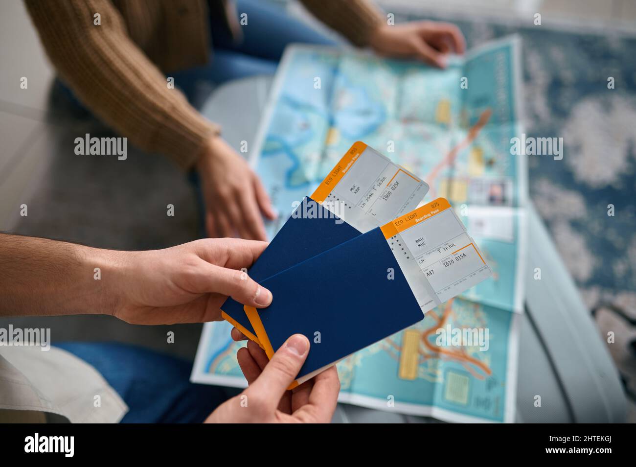 Closeup ticket in hand over guide map Stock Photo