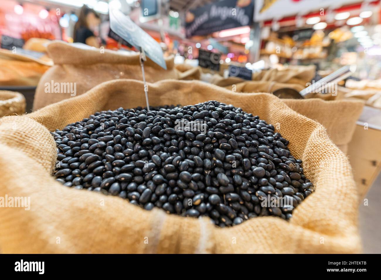 Black beans in a sack at a vegetable stall in the market. Close up shot. Stock Photo
