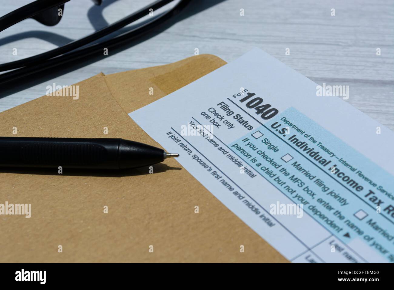 Tax forms 1040. U.S Individual Income Tax Return in an brown envelope on a desk. Stock Photo