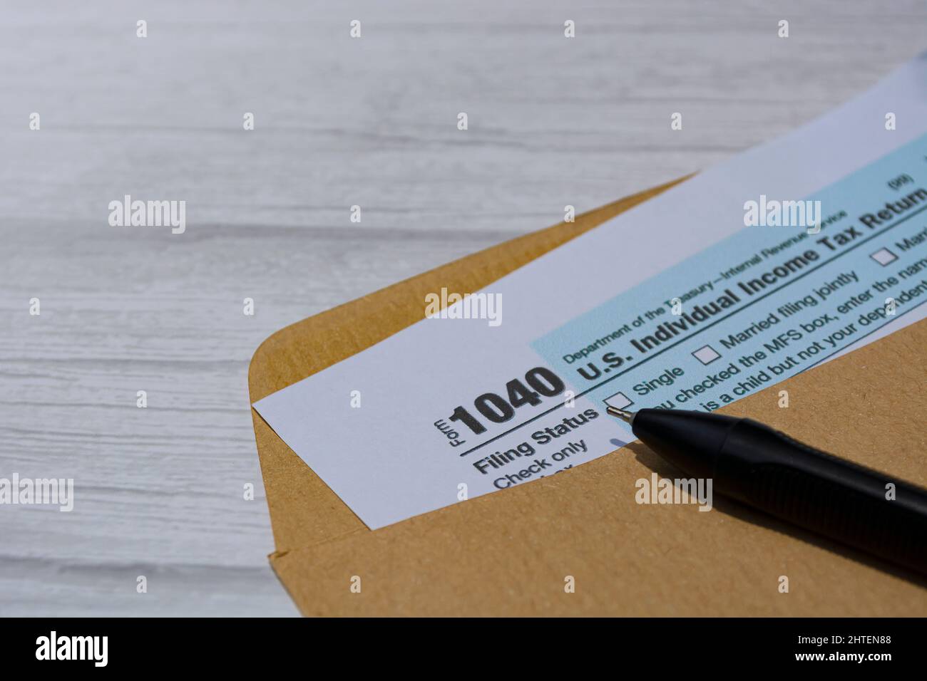 Tax forms 1040. U.S Individual Income Tax Return in an brown envelope on a desk. Stock Photo
