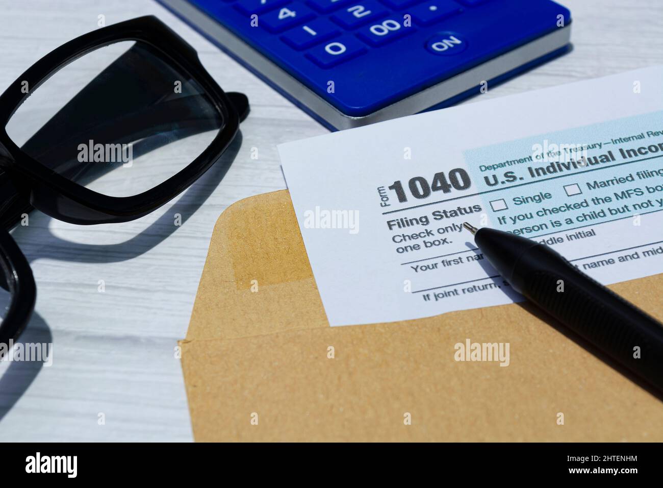 Tax forms 1040. U.S Individual Income Tax Return in an brown envelope on a desk. Stock Photo