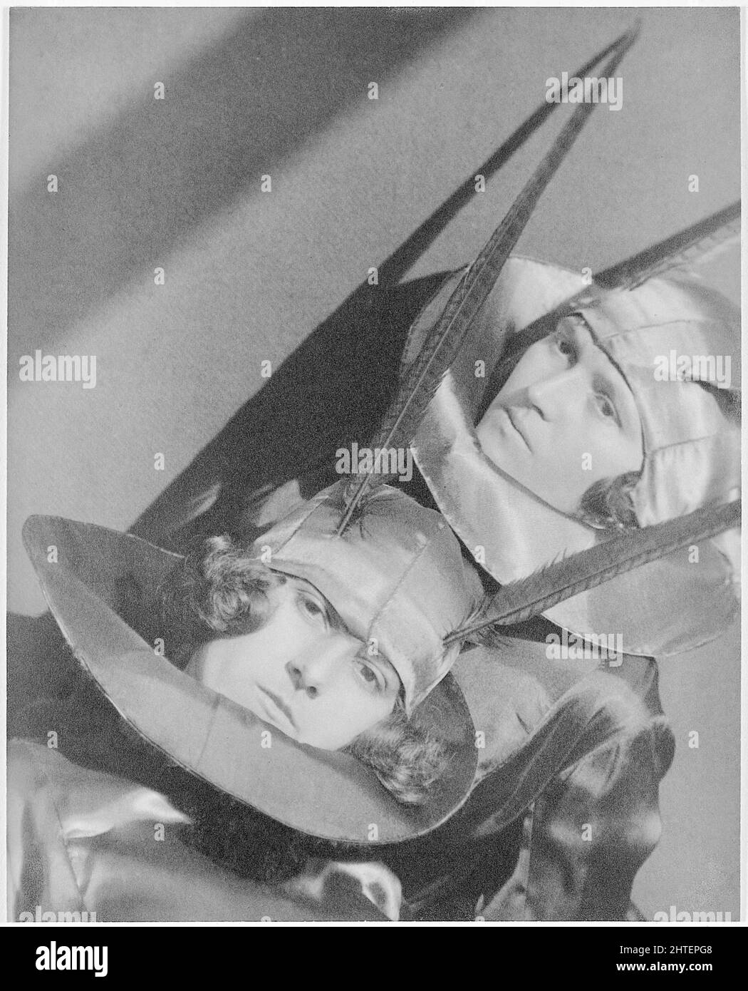 Jaromir Funke (Czech Photographer) - After the Carnival - circa 1924 - Two people with feathers sticking out from aviator caps - Weird Stock Photo