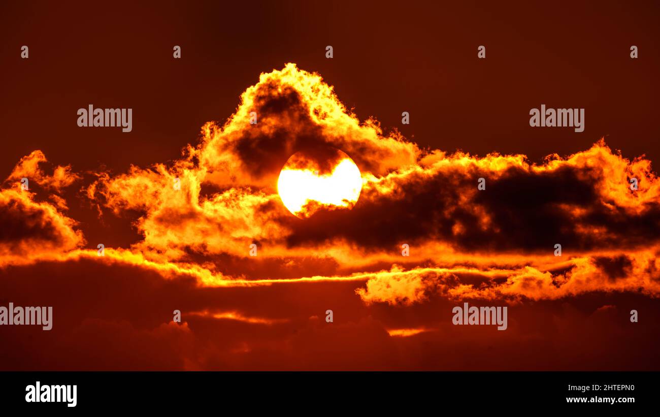 Sky with sun in clouds of altitude. Cloud the evening sky at sunset Stock Photo