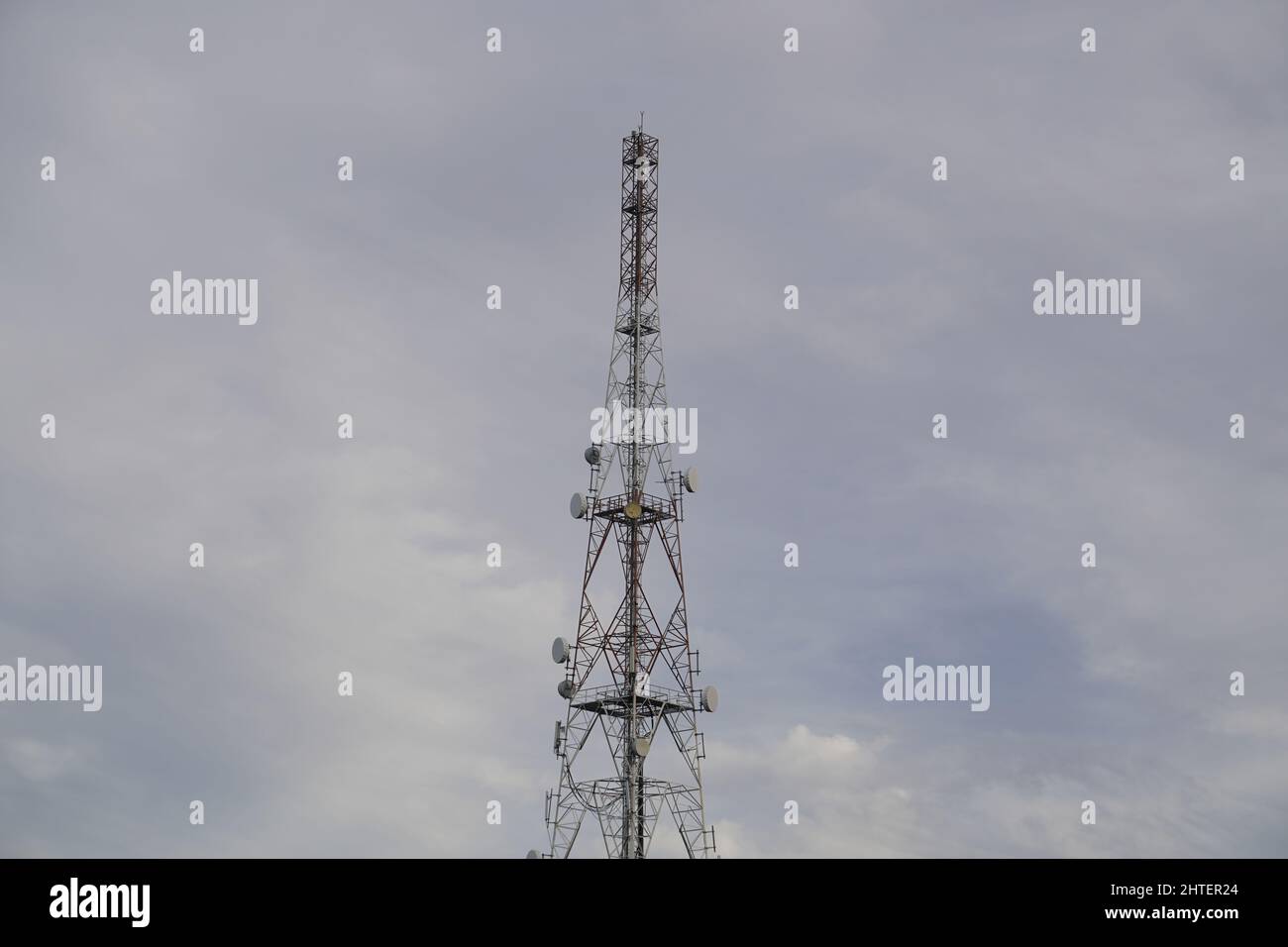 Tall cellphone tower against a gloomy sky Stock Photo Alamy