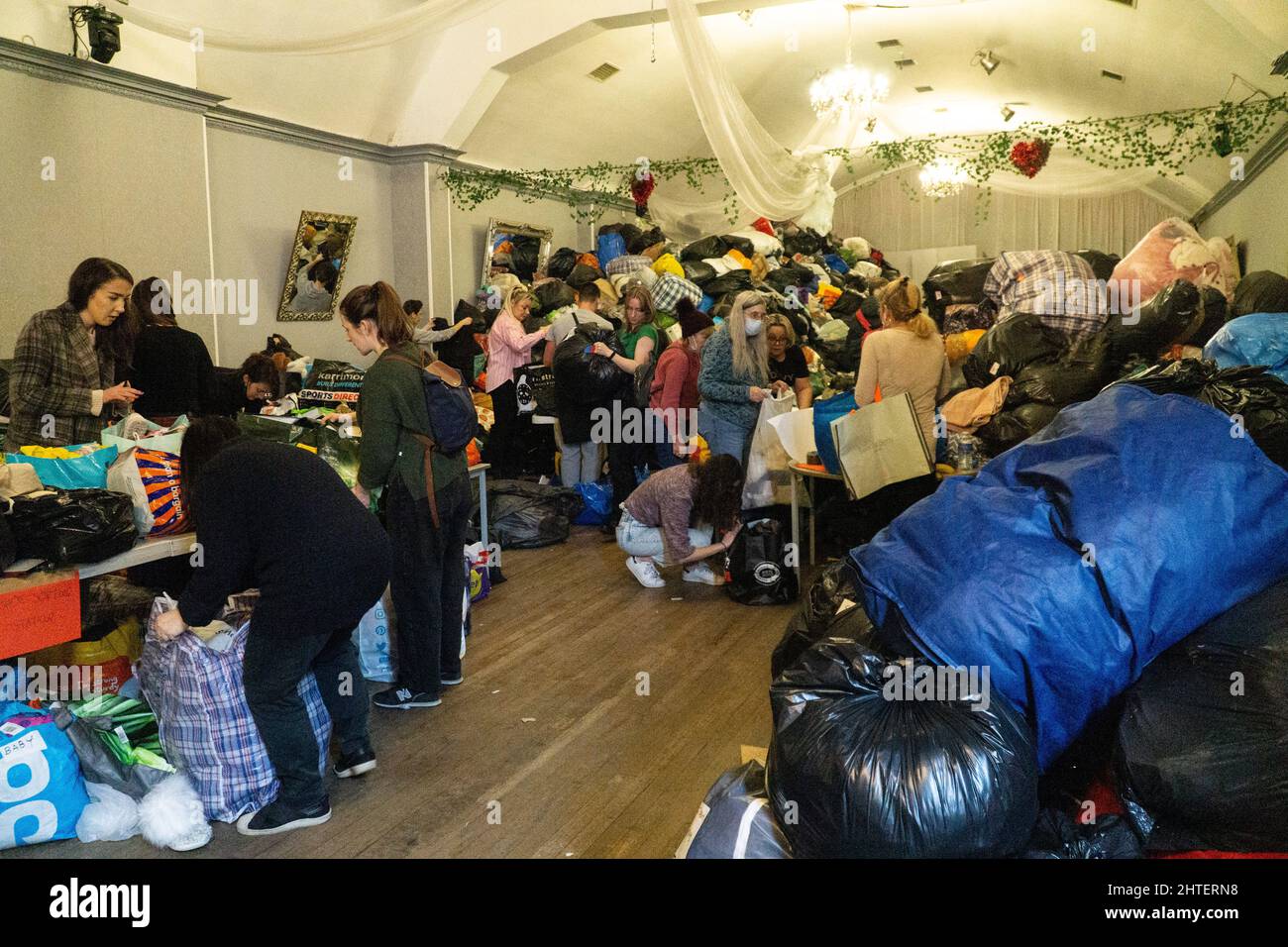 London, UK, 28 February 2021: Aid donations for Ukranian refugees are gathered at the White Eagle Club, a Polish community centre in Balham. Huge quantities have been donated and are being sorted by volunteers and then loaded on to pallets to take on lorries across Europe. Anna Watson/Alamy Live News Stock Photo