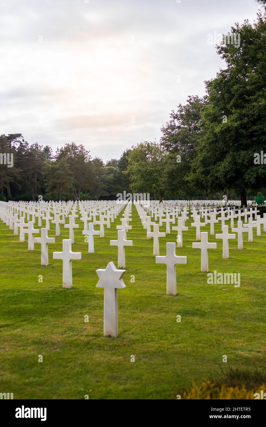 American military cemetery in Normandy. White crosses and blue sky with ...
