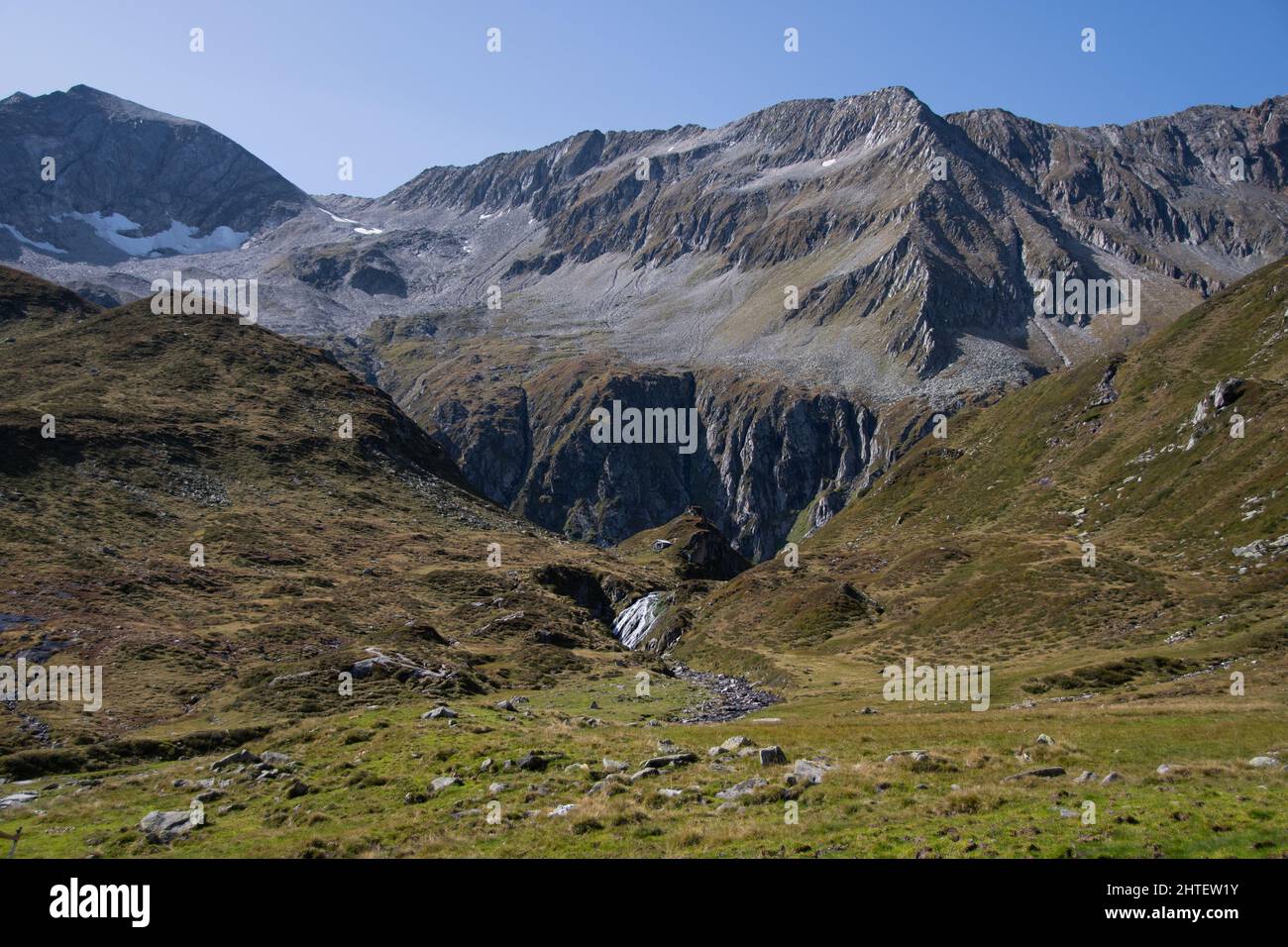 Breathtaking landscape in Obersulzbachtal with mountains and a waterfall Stock Photo