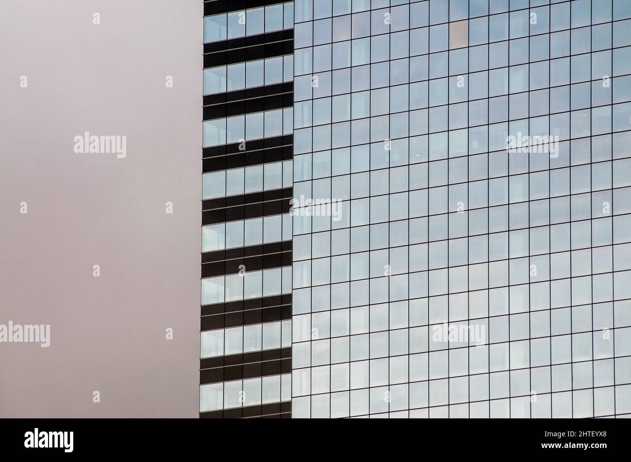 Closeup of the exterior of a a building with big glass windows Stock