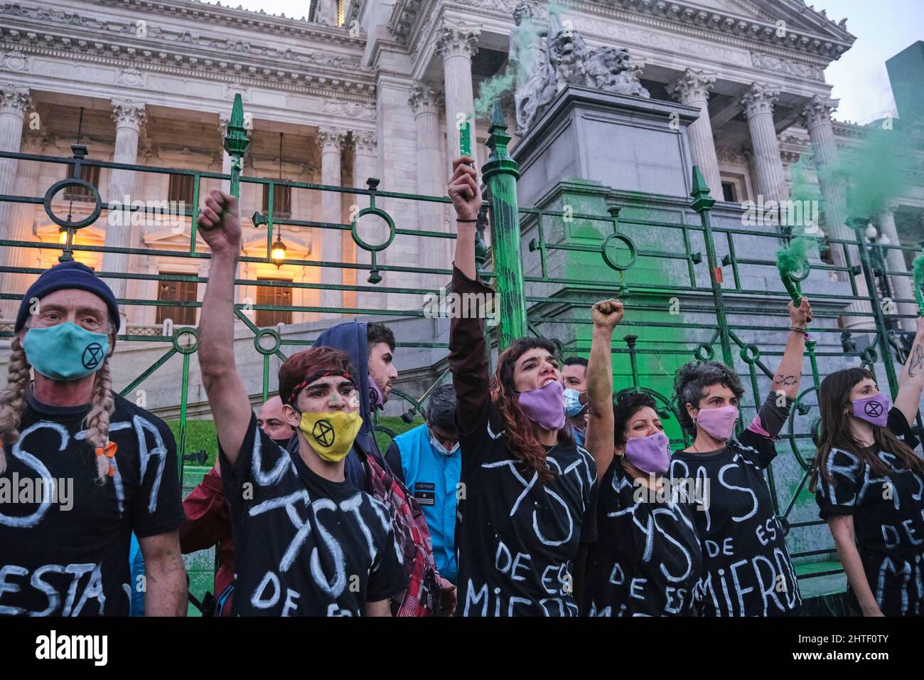 Buenos Aires, Argentina; Sept 24, 2021: Global Climate Strike, group of young activists of XR put on a green smoke performance in front of the Nationa Stock Photo