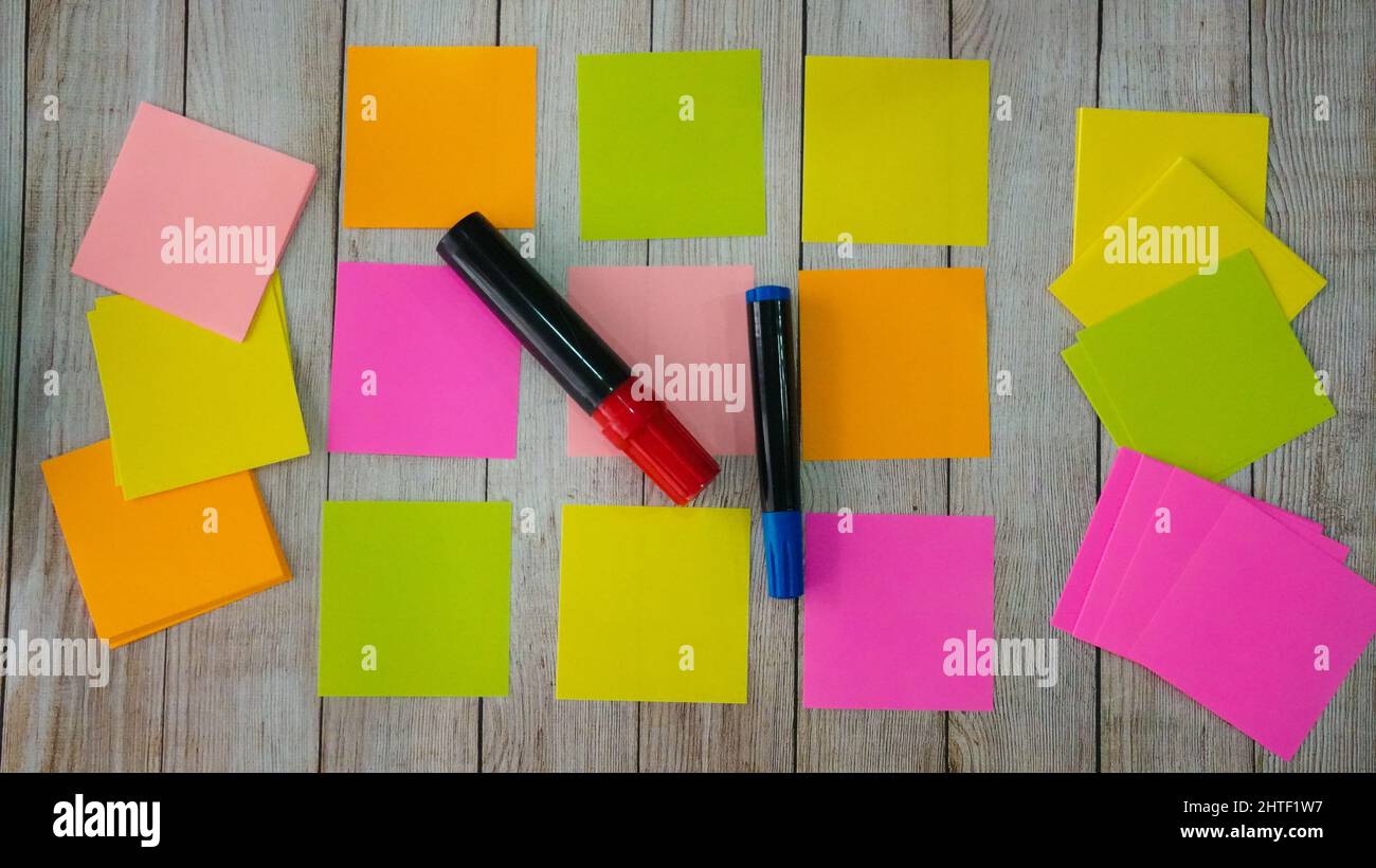 Flat lay with colorful stickers and markers on the wooden background ...