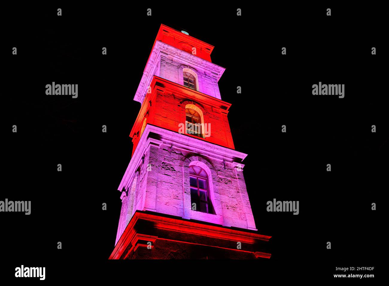 Night photo of Bursa, Ottoman clock tower in Bursa, Turkey, colorful illumination at night local name is tophane saat kulesi. Stock Photo