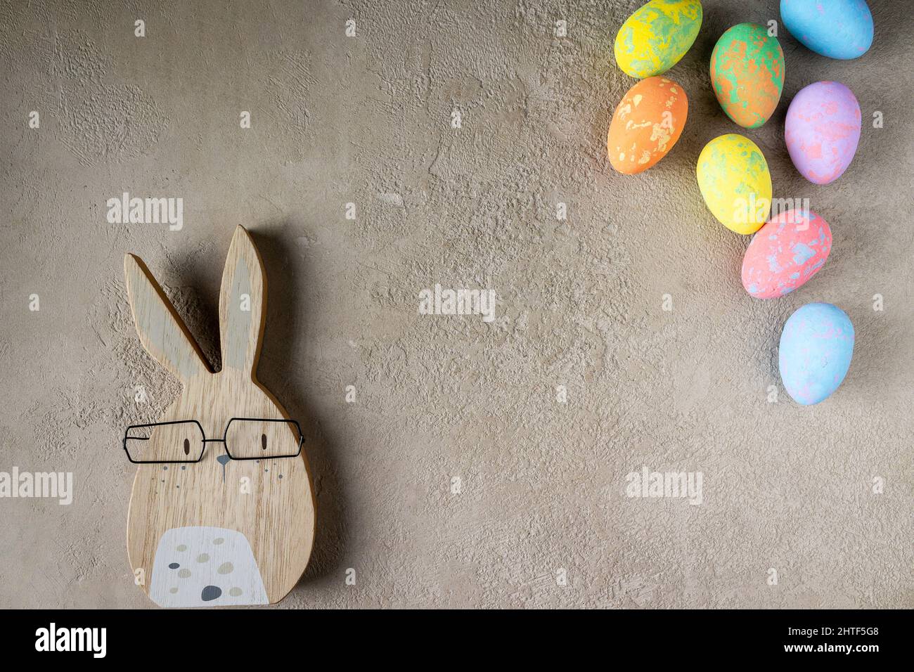 rabbit and colored easter eggs on a gray background, copy space Stock Photo
