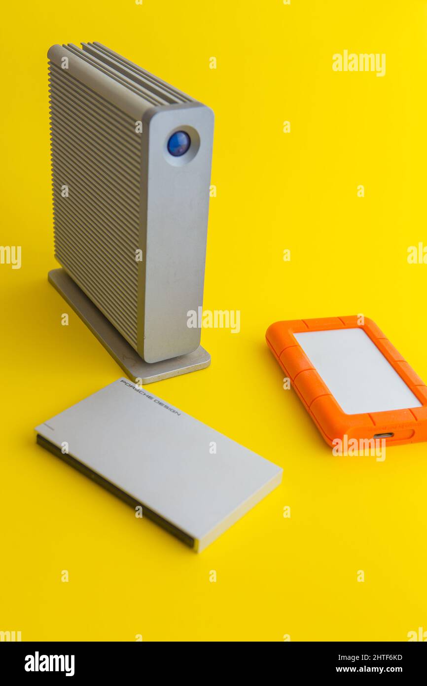 selection of external hard drives on a yellow background Stock Photo