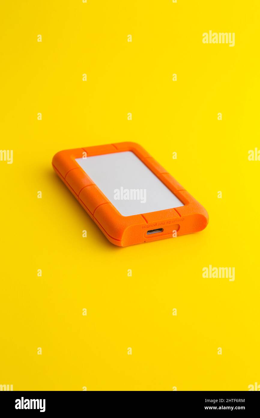 external hard drive on a yellow background Stock Photo - Alamy