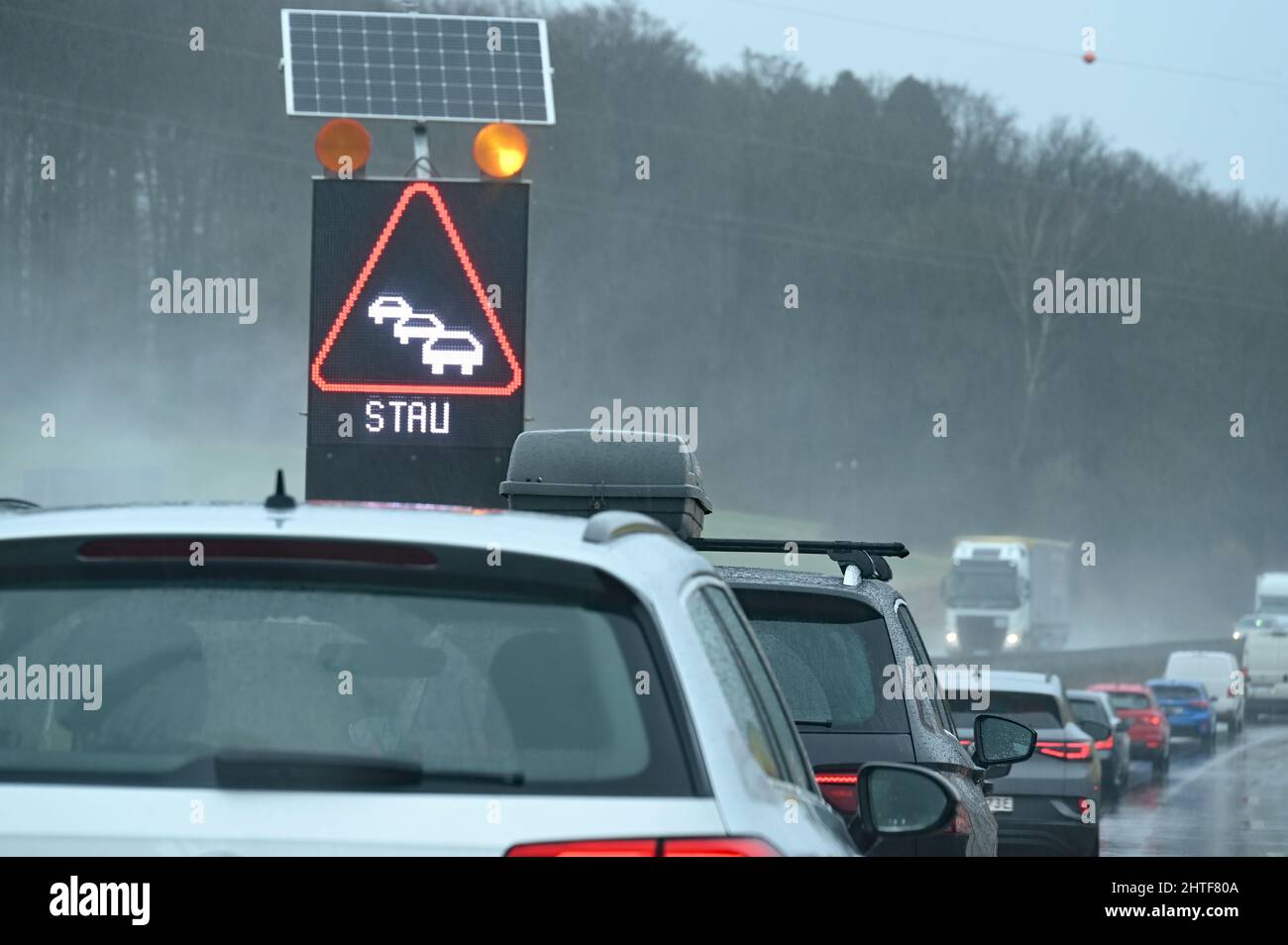 Traffic jam on the highway in the rain Stock Photo