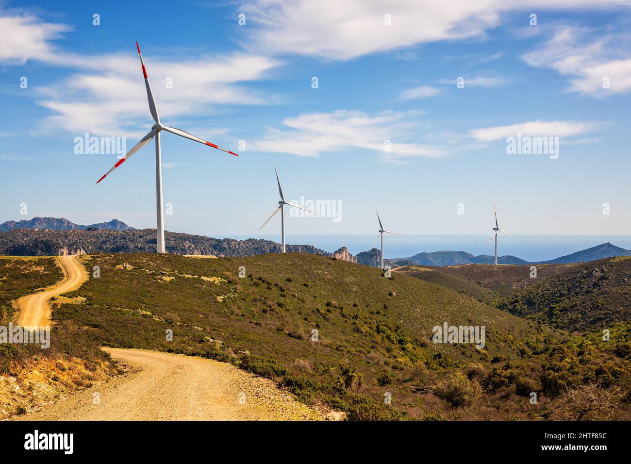 Wind turbines on a beautiful blue sky with clouds in a mountain wind