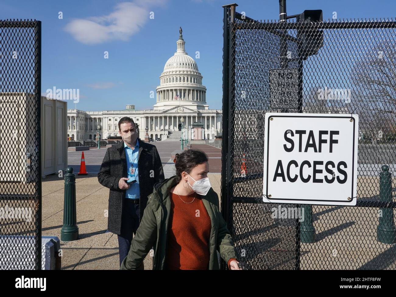Washington, United States. 28th Feb, 2022. Congressional staff walk through an exit in the fencing around the US Capitol Building in Washington DC on Monday, February 28, 2022. The fencing was erected by the US Capitol Police once before following the January 6, 2021 riots and was reinstalled this year prior to the March 1, 2022 State of The Union address by President Biden and the arrival of a trucker caravan coming to Washington DC to protest COVID restrictions. Photo by Jemal Countess/UPI Credit: UPI/Alamy Live News Stock Photo