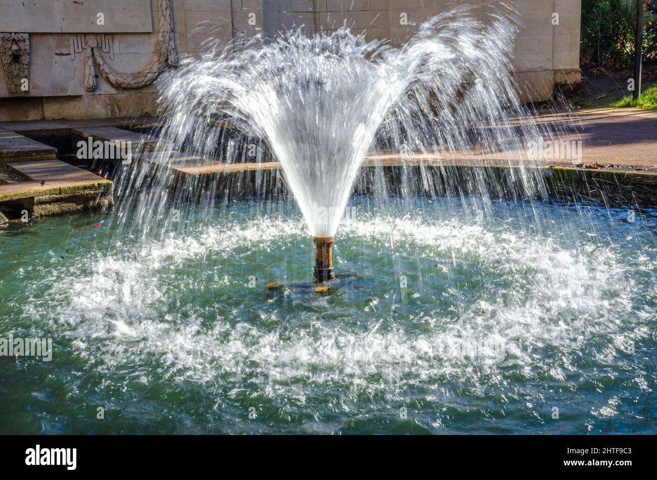 A fountain in London Memorial Garden is a focal point and water feature. Stock Photo