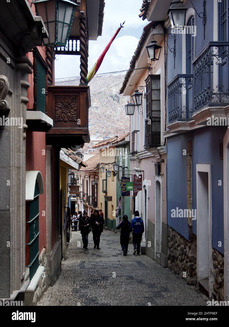Vertical shot of a group of people walking near historic buildings in