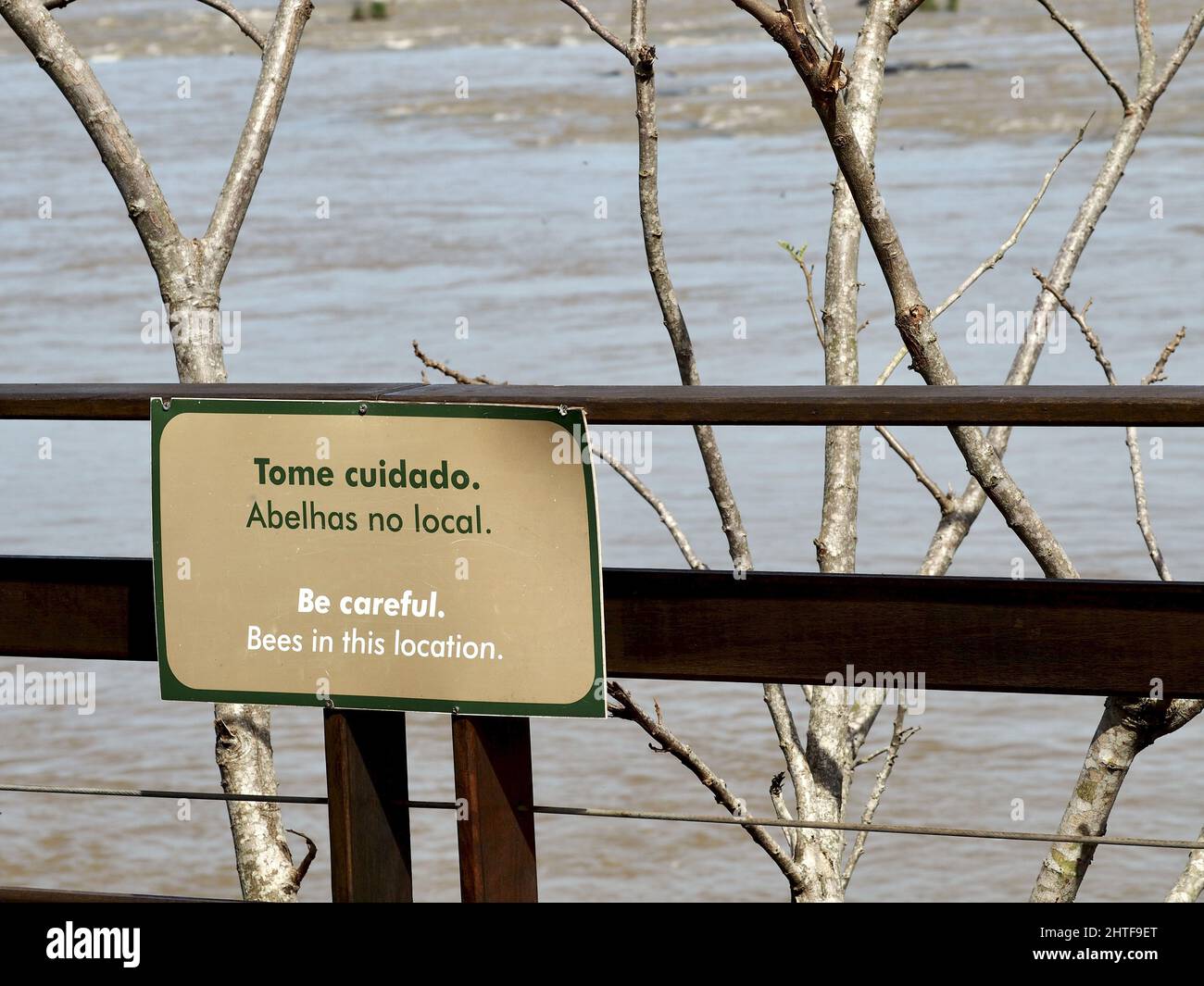 Sign warning about bees in the location in Itaipu Dam, Brazil Stock Photo