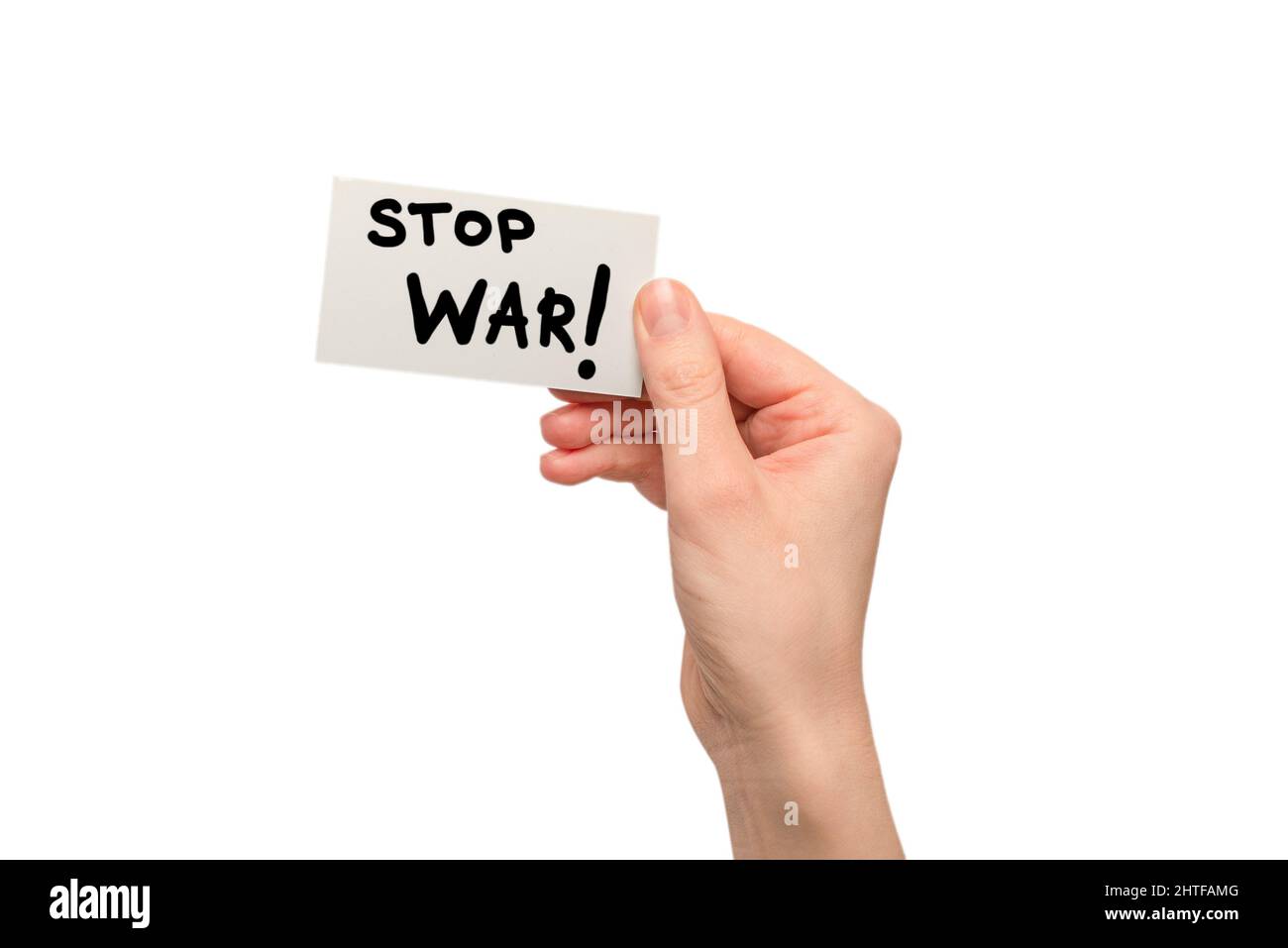 Stop war text on a card isolated on a white background in woman hands. Stock Photo