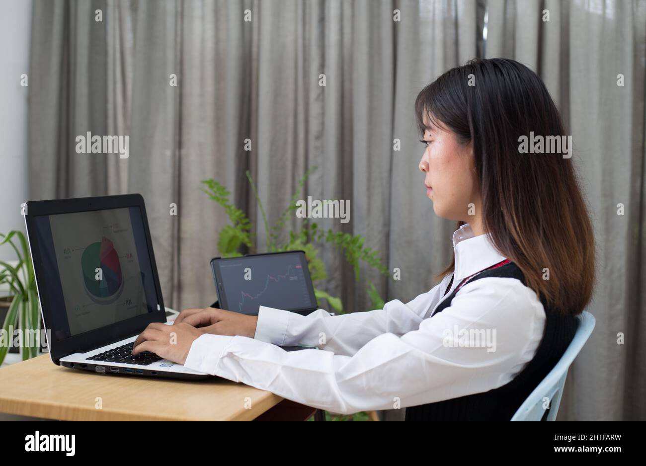 Young Malaysian female sitting at her desk and working Stock Photo Alamy